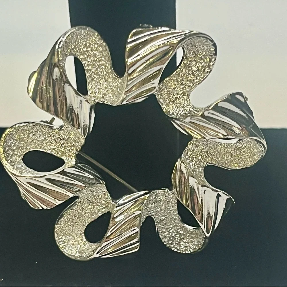 Two Elegant Silver tone Sarah Coventry brooches.